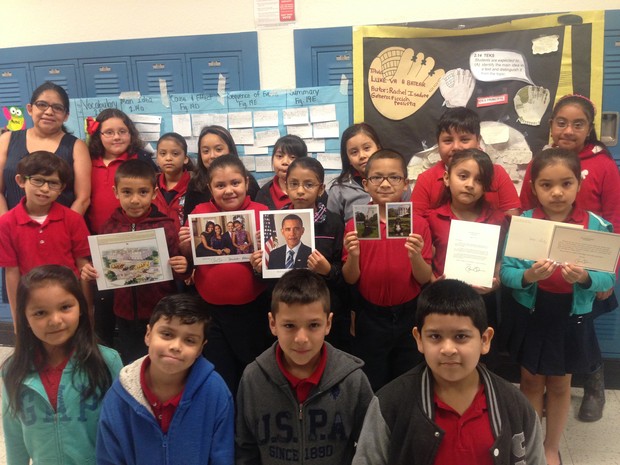 Knight Elementary students show off the photos they received in a letter from President Barack Obama.