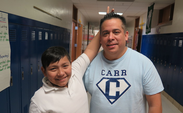 Diego gives bunny ears to Ricky Puente, a counselor at Carr Elementary.