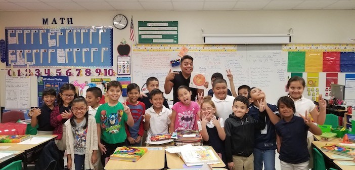 Univision's Daniel Luna poses with students at Tatum Elementary School.