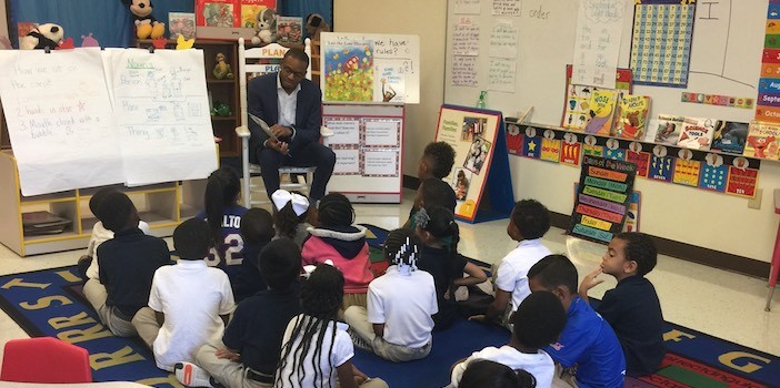 Trustee Justin Henry reads to students at Tatum Elementary School.