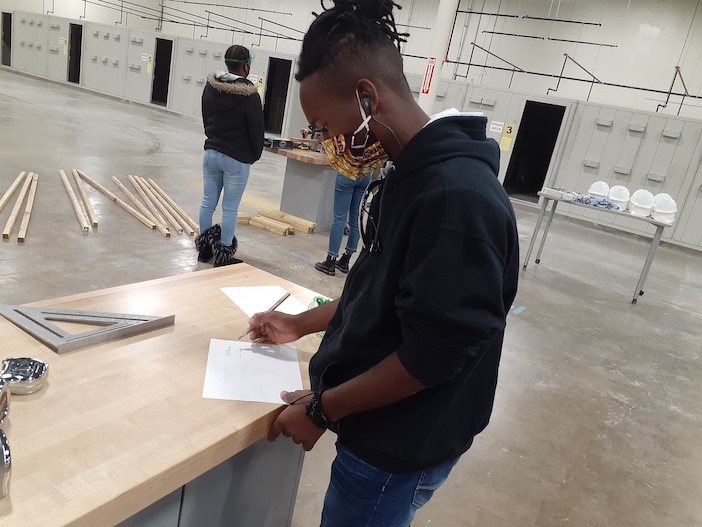 Dallas ISD Teen School Board members build desks for fellow students