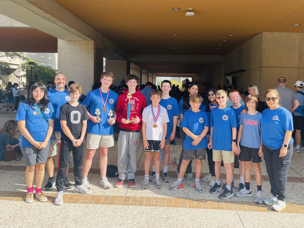 Group of students holding trophies and wearing medals at the TMSCA competition