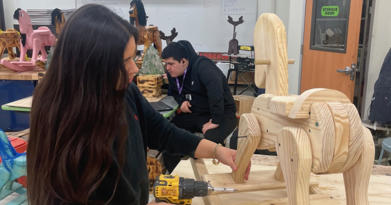 Students at Career Institute South craft rocking horses to brighten holiday season
